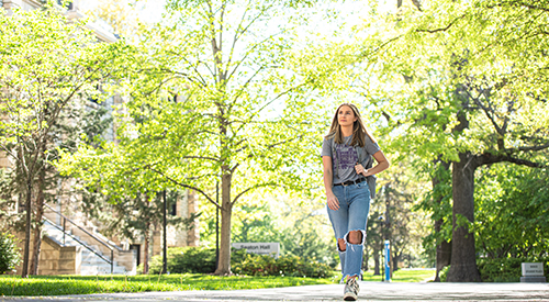 student walking on campus in spring